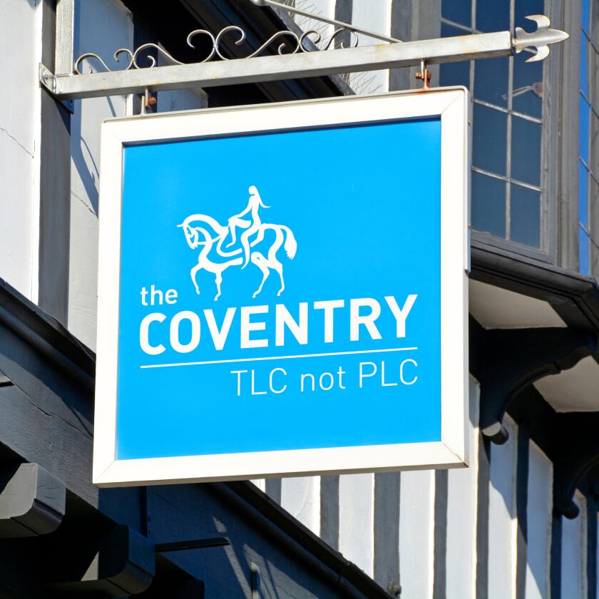Sign above "The Coventry Building Society" branch premises in Stratford upon Avon includes slogan "TLC not PLC" and Lady Godiva