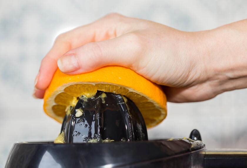 Squeezing orange to extract some healthy juice.