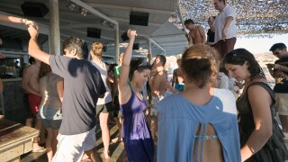 Mykonos, Greece. Tourists dancing at the Tropicana Club on Paradise Beach