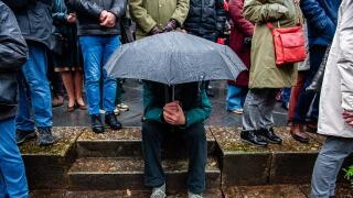 Nijmegen, Netherlands. 22nd Feb, 2024. A man shelters underneath an umbrella during the event. The 80th commemoration of the Bombing of Nijmegen which was unplanned attack by American aircraft on the city of Nijmegen, on 22 February 1944. Every February 2