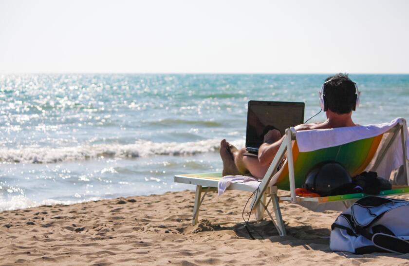 Remote Working Concept - Man at work from the beach