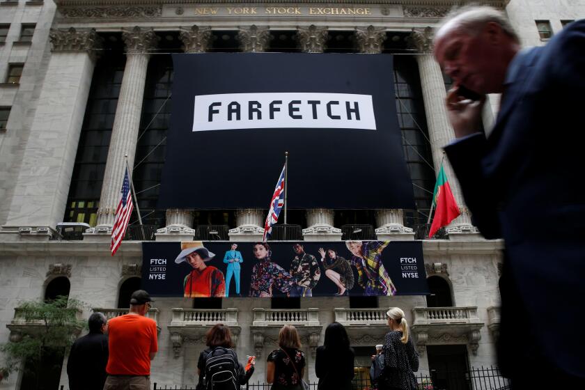 A banner to celebrate the IPO of online fashion house Farfetch is displayed on the facade of the of the New York Stock Exchange (NYSE) in New York, U.S., September 21, 2018. REUTERS/Brendan McDermid