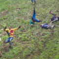 Gloucester, UK. The annual cheese rolling race held at Coopers Hill, Brockworth outside Gloucester. Competitors race down the extremly steep slippery hill chasing a double Gloucester cheese, the winner of each race recieves the cheese as thier prize.