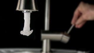 high speed image - beginning water outlet out of a tap