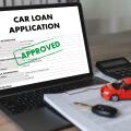 Online car loan application form displayed on laptop with calculator, vehicle model, financial documents, and car key for digital financing, banking a