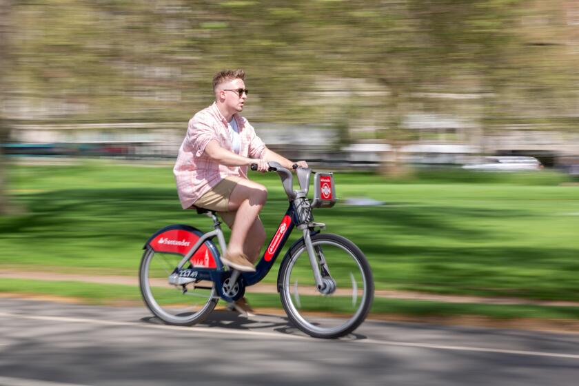 Cyclist using Santander Cycle Hire Scheme, London, UK