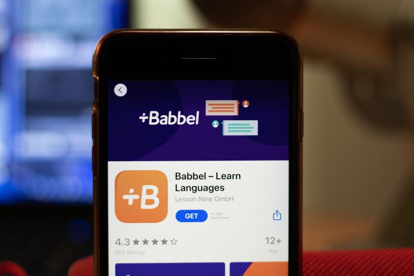Los Angeles, California, USA - 16 April 2020: Babbel logo on screen close up. App store icon visible on phone display with blurry background