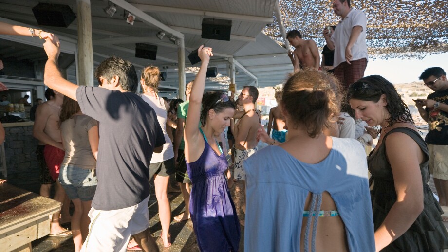 Mykonos, Greece. Tourists dancing at the Tropicana Club on Paradise Beach