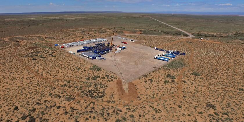Vaca Muerta, Argentina, December 2, 2014: Extraction of unconventional oil. Battery of pumping trucks for hydraulic fracturing (Fracking).