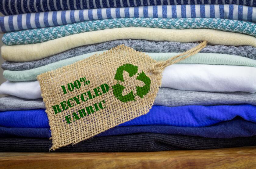 Recycle clothes icon on fabric label with 100% Recycled text, concept illustration reuse, recycle clothes and textiles to reduce waste
