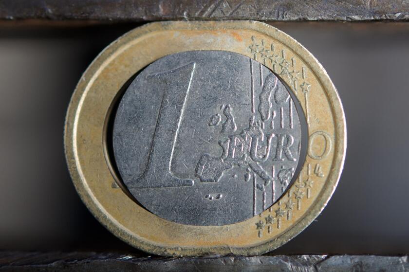 ILLUSTRATION - This illustration shows a damaged euro coin in a vise in Stuttgart, Germany, 15 December 2011. Photo: Michele Danze