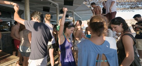 Mykonos, Greece. Tourists dancing at the Tropicana Club on Paradise Beach