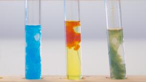 Three test tubes containing (left to right) precipitate of copper hydroxide, precipitate of iron (III) hydroxide and precipitate of iron (II) hydroxid