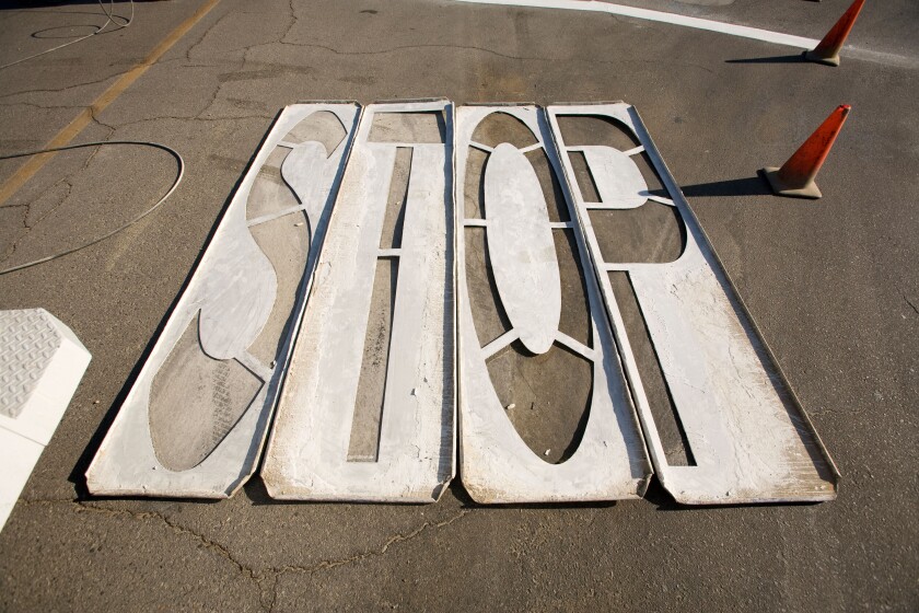 Wood stencils for painting STOP on pavement laying on asphalt street with orange traffic cones Indio California USA. Image shot 2009. Exact date unknown.
