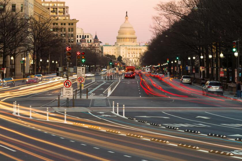 Traffic creates light trails and motion blurs leading to the US Capitol Building on Pennsylvania Avenue in Washington, DC.
