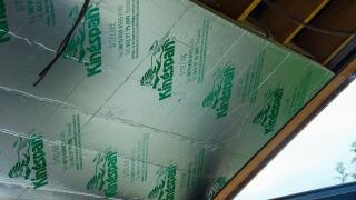 Kingspan insulation being installed on the inside of the roof of a sunroom.