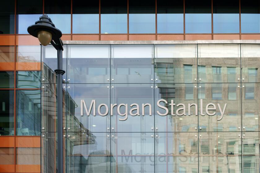 Facade of the modern bank of Morgan Stanley with reflections and a nostalgic lantern in London,