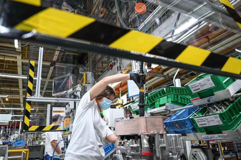 Friedrichshafen, Germany. 12th May, 2020. In plant two of the automotive supplier ZF Friedrichshafen, mechanic Vanessa is working on a transmission brake called ZF Intarder. ZF Friedrichshafen slowly restarts operations with protective and hygienic measur