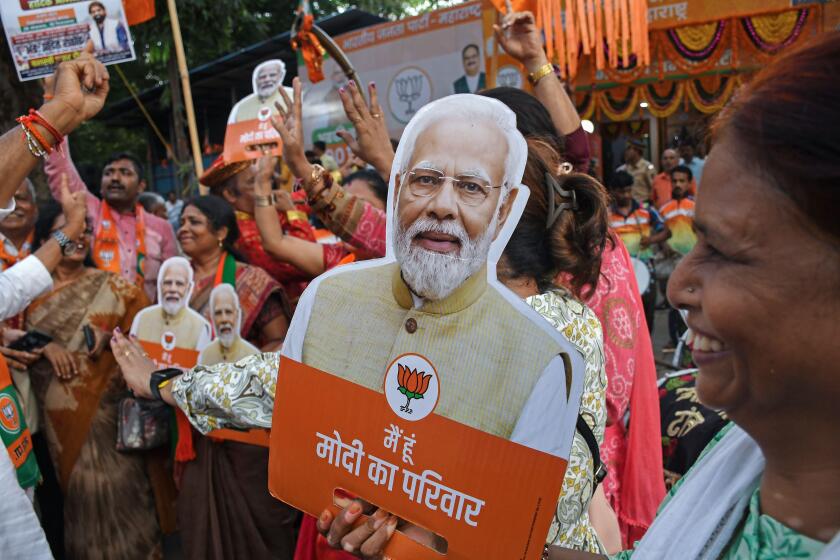 Mumbai, India. 04th June, 2024. A supporter of the Bharatiya Janata Party (BJP) holds a cut out of India's Prime Minister Narendra Modi as they celebrate the victory outside the Bharatiya Janata Party (BJP) office. Supporters of Bharatiya Janata Party (BJ