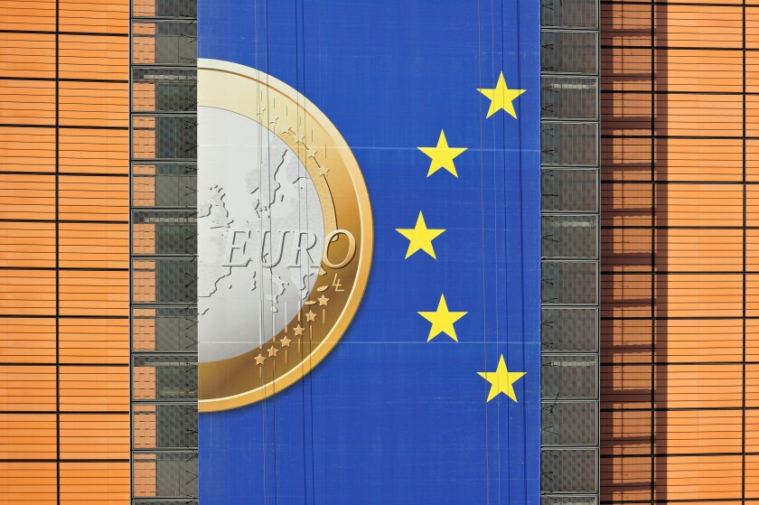 Banner about the euro hanging from building of the European Commission, executive body of European Union in Brussels, Belgium