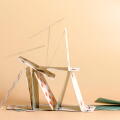 Crashed house of cards. Falling cards on beige background