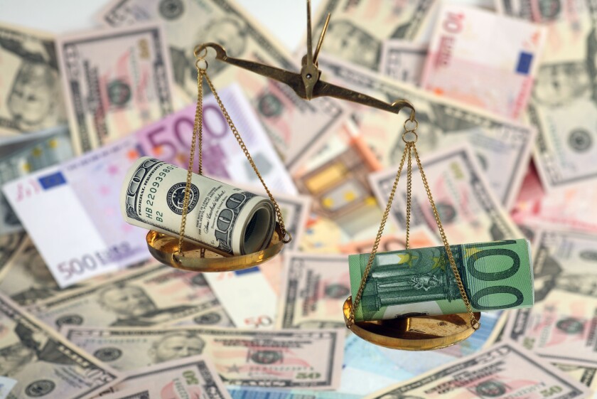 Unbalanced scales with dollar and euro banknotes