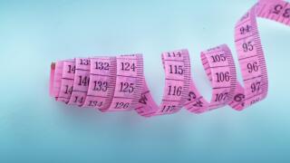 Coiled pink textile tape measure