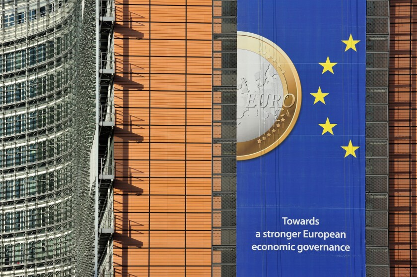 Banner about the euro hanging from building of the European Commission, executive body of European Union in Brussels, Belgium