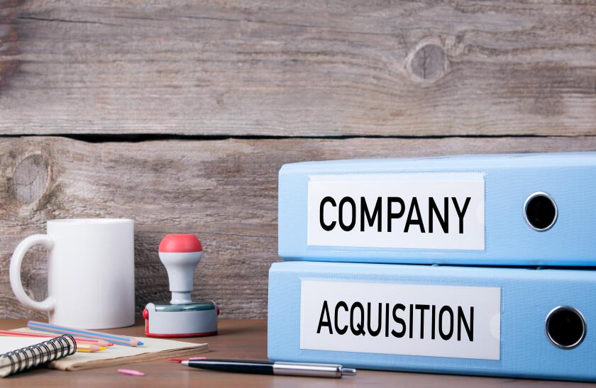 Company and Acquisition. Two binders on desk in the office. Business background