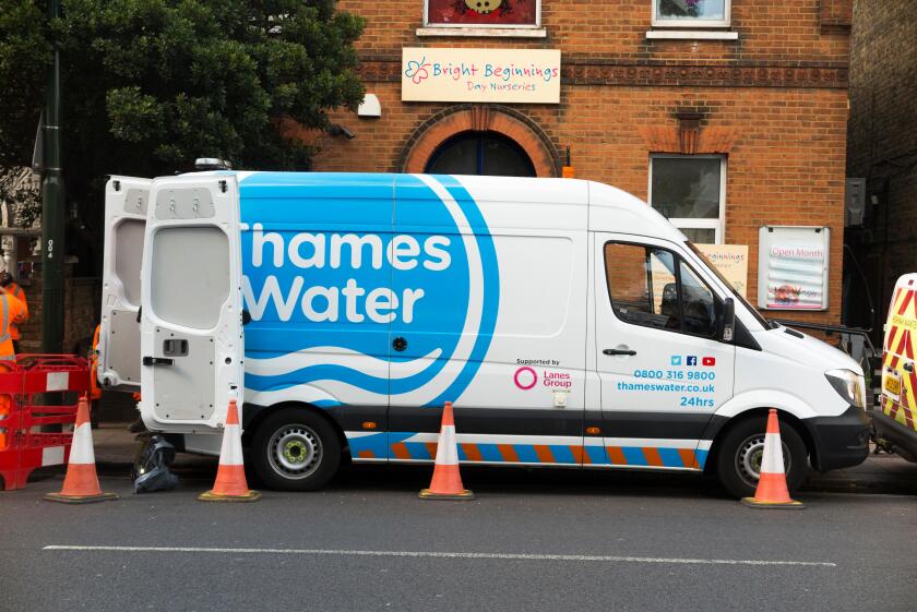 Thames water lorry / van / vans / vehicles at the site of a blocked pipe / drain / drainage / sewer blockage attended by their staff and workers in Twickenham, West London. UK (96)