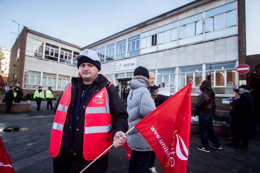 A bus Driver on strike outside Telford Avenue bus depot owned by Arriva.