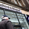 Commuters pass by a branch of Bradford & Bingley in central London, United Kingdom in 2009.