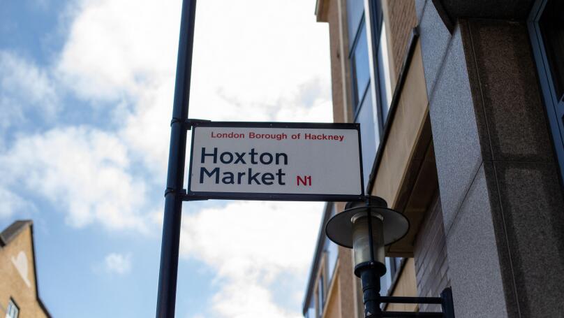 Street sign for Hoxton Market in the London Borough of Hackney under a clear sky.