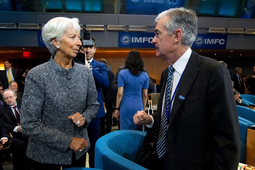 International Monetary Fund (IMF) Managing Director Christine Lagarde speaks with Federal Reserve Board Chair Jerome Powell during the International Monetary and Financial Committee meeting, at the World Bank/IMF Spring Meetings in Washington, Saturday, 