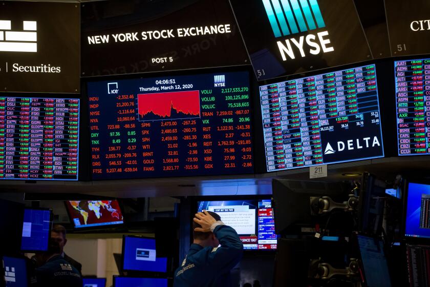 New York, USA. 13th Mar, 2020. A trader works at the New York Stock Exchange (NYSE) in New York, the United States, March 12, 2020. Intensifying coronavirus fears battered Wall Street on Thursday with a historic nosedive in its worst session since the 198