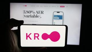 Stuttgart, Germany - 10-08-2025: Person holding cellphone with logo of British financial company Kroo Bank Ltd. on screen in front of webpage.