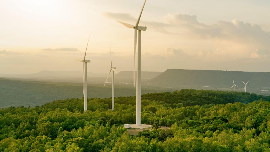 Wind energy. Wind power. Sustainable, renewable energy. Wind turbines generate electricity. Windmill farm on mountain with sunset sky. Green technology. Renewable resource. Sustainable development.