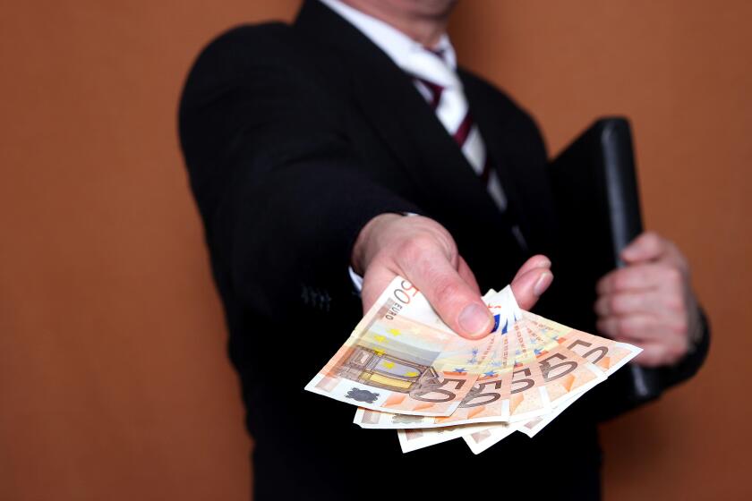 businessman offering Euro banknotes