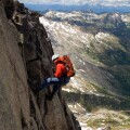 Male alpine rock climber steep cliff Kane Peak