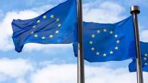 Close up of two European Union Flags flying outside the Berlaymont Building in Brussels, Belgium.