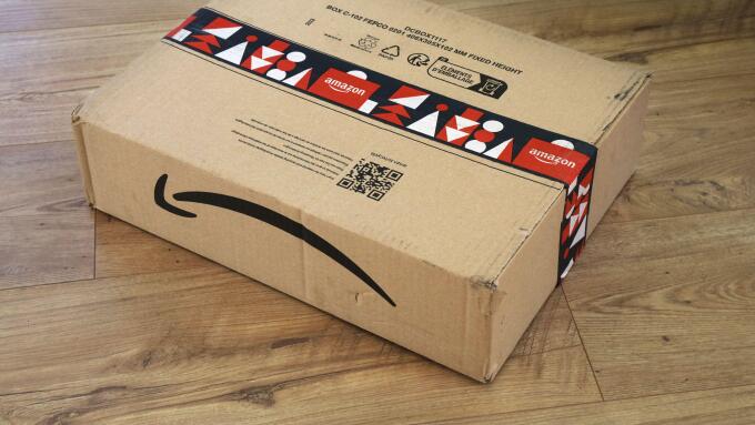 WARSAW, POLAND - DECEMBER 18, 2023: Amazon online store order box package delivered in Europe before Christmas, with holiday design tape.