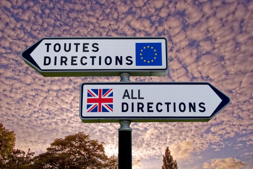 French style double signpost with opposing UK/EU pointers.