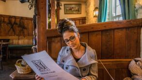 Girl reading menu at pub