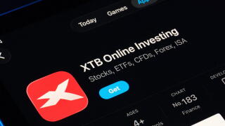 XTB Online Investing listing captured on iPad, Apple Liquid Glass look in iOS 26 highlights refreshed UI and typography. Stafford, United Kingdom, Sep
