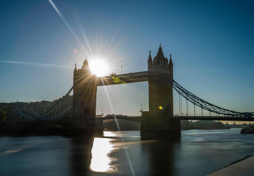 The rising sun captured in a long exposure next to Tower Bridge, London, UK.
