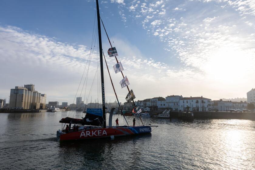 LES SABLES D'OLONNE, FRANCE - NOVEMBER 08, 2020: Sebastien Simon boat (Arkea - Paprec) in the channel for the start of the Vendee Globe 2020