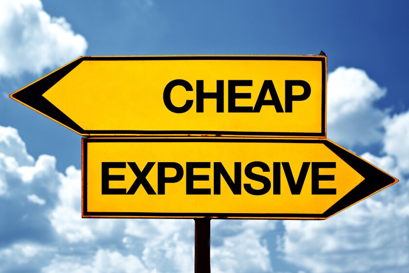 Cheap or expensive, opposite signs. Two opposite signs against blue sky background.