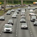 Cars and trucks travel along the M6 north in Warrington during a bustling afternoon, showcasing the rhythm of everyday life on this major highway.