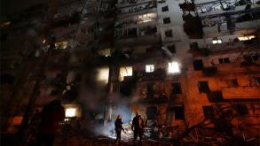 Kiev, Ukraine. 24th Feb, 2022. Ukrainian firefighters respond to the a rocket attack on a residential building attacked by Russian military forces during the invasion February 25, 2022 near Kiev, Ukraine. Credit: State Emergency Service of Ukraine/State E