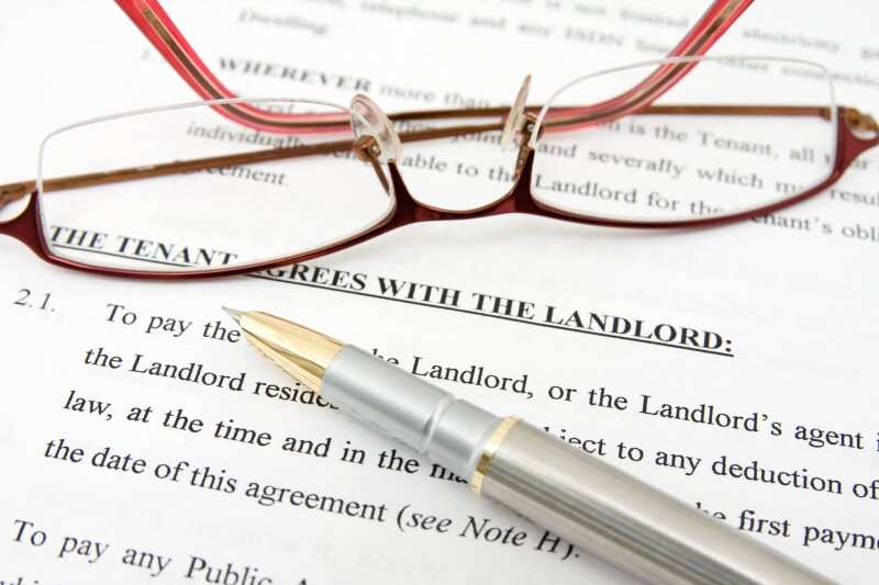 pen,glasses and tenant agreement with the landlord